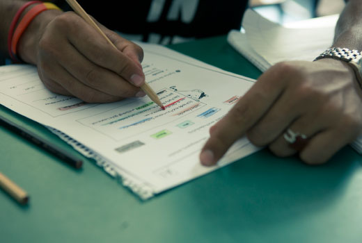 Close-up shot: a man performs a written task.