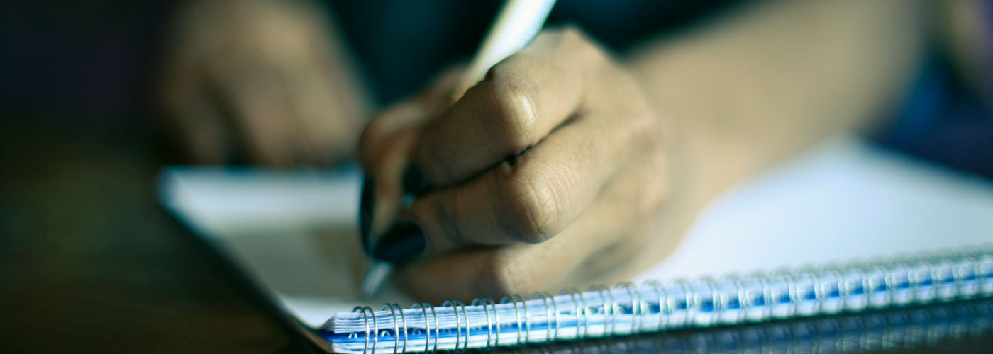 Close-up shot: a woman performs a written task.