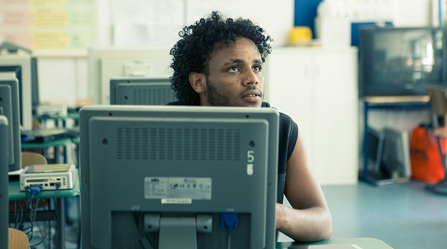 Classroom situation: students learning in the computer room at the bridging school.