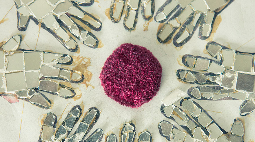 Hands made out of mosaic stones forming a circle.